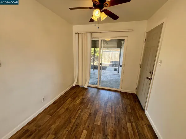 a view of room with wooden floor and fan