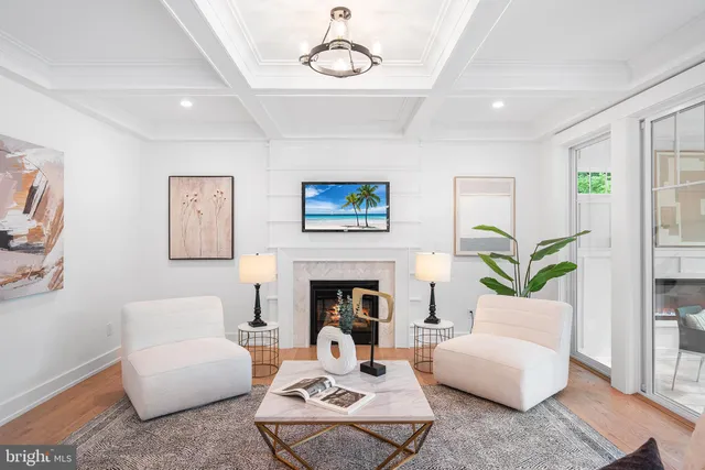 a living room with furniture fireplace and rug