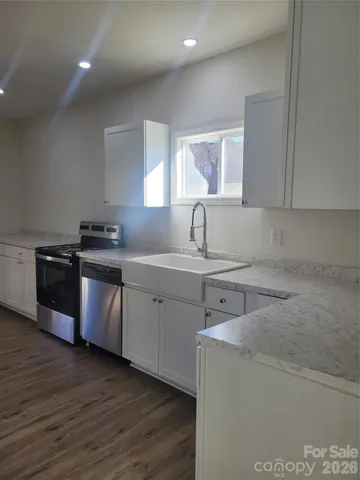 a kitchen with sink a microwave and cabinets