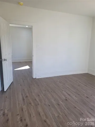 a view of room with wooden floor