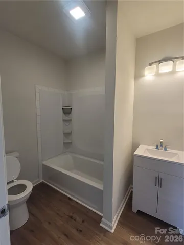 a bathroom with a toilet a sink and bathtub