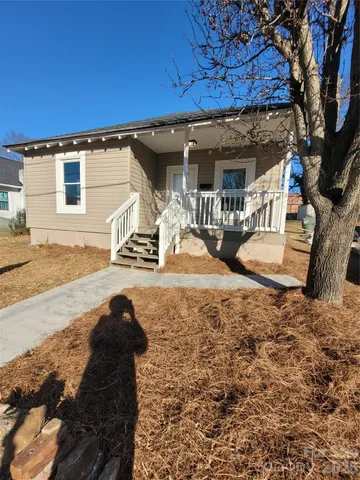 a view of a backyard with wooden fence