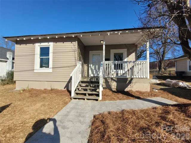 a view of a house with wooden floor and a fence