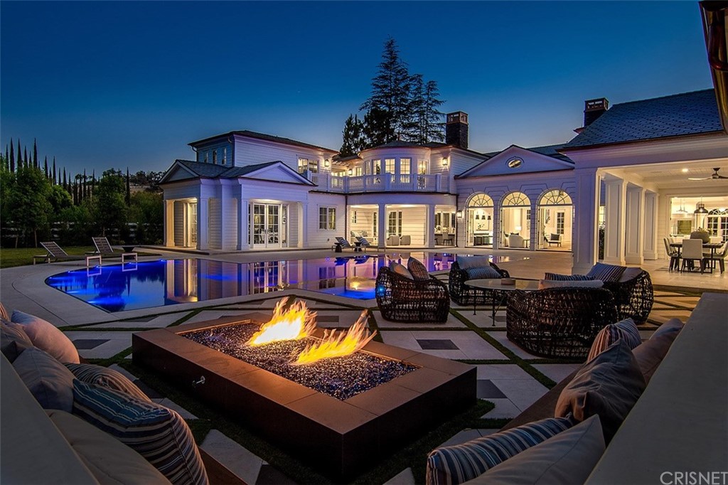 a living room with furniture a chandelier and a dining table