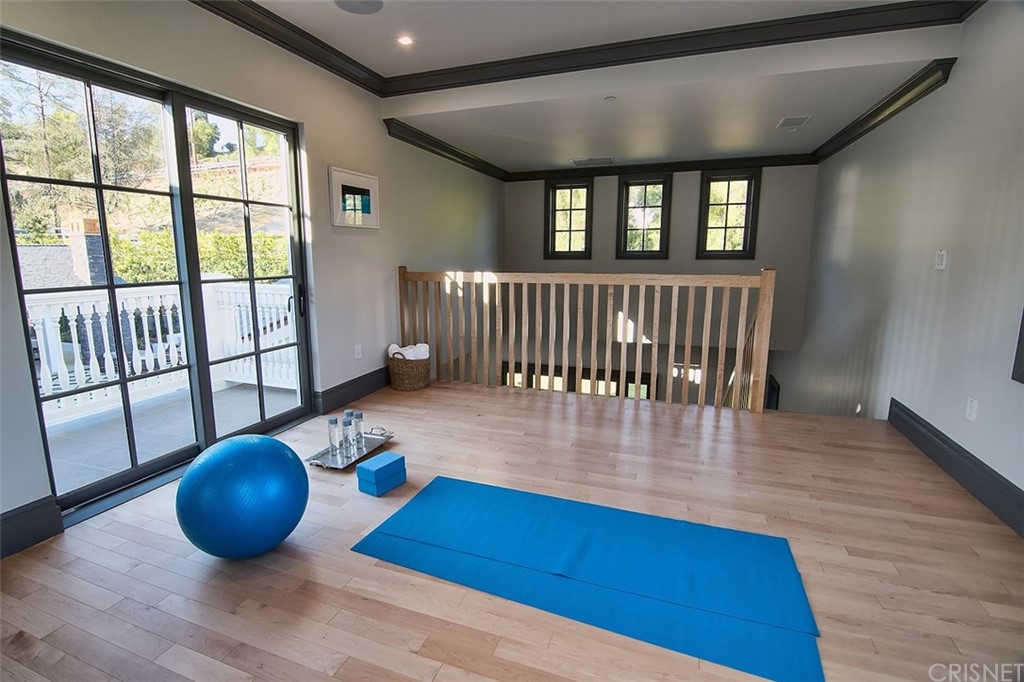 5546 Jed Smith Road Hidden Hills, CA 91302 - Photo 22 of 75 a view of a livingroom with a chair and wooden floor