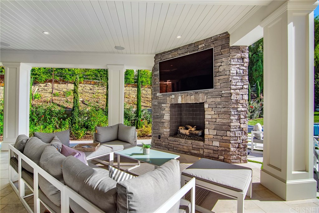 5546 Jed Smith Road Hidden Hills, CA 91302 - Photo 43 of 75 a living room with furniture a flat screen tv and a fireplace