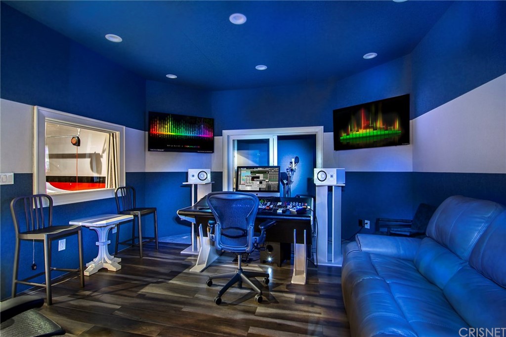 5546 Jed Smith Road Hidden Hills, CA 91302 - Photo 64 of 75 a living room with furniture and a flat screen tv