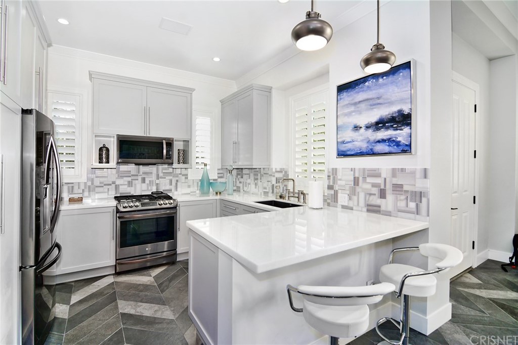 5546 Jed Smith Road Hidden Hills, CA 91302 - Photo 68 of 75 a kitchen with a sink a stove a refrigerator and a fireplace