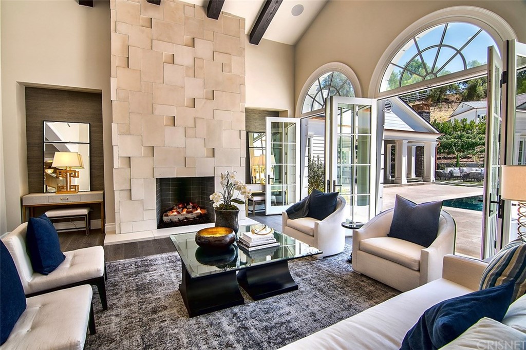 5546 Jed Smith Road Hidden Hills, CA 91302 - Photo 9 of 75 a living room with furniture a fireplace and a large window