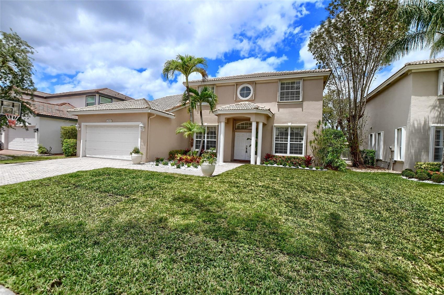 12920 Hyland Circle Boca Raton, FL 33428 - Photo 20 of 31 front view of a house with a yard