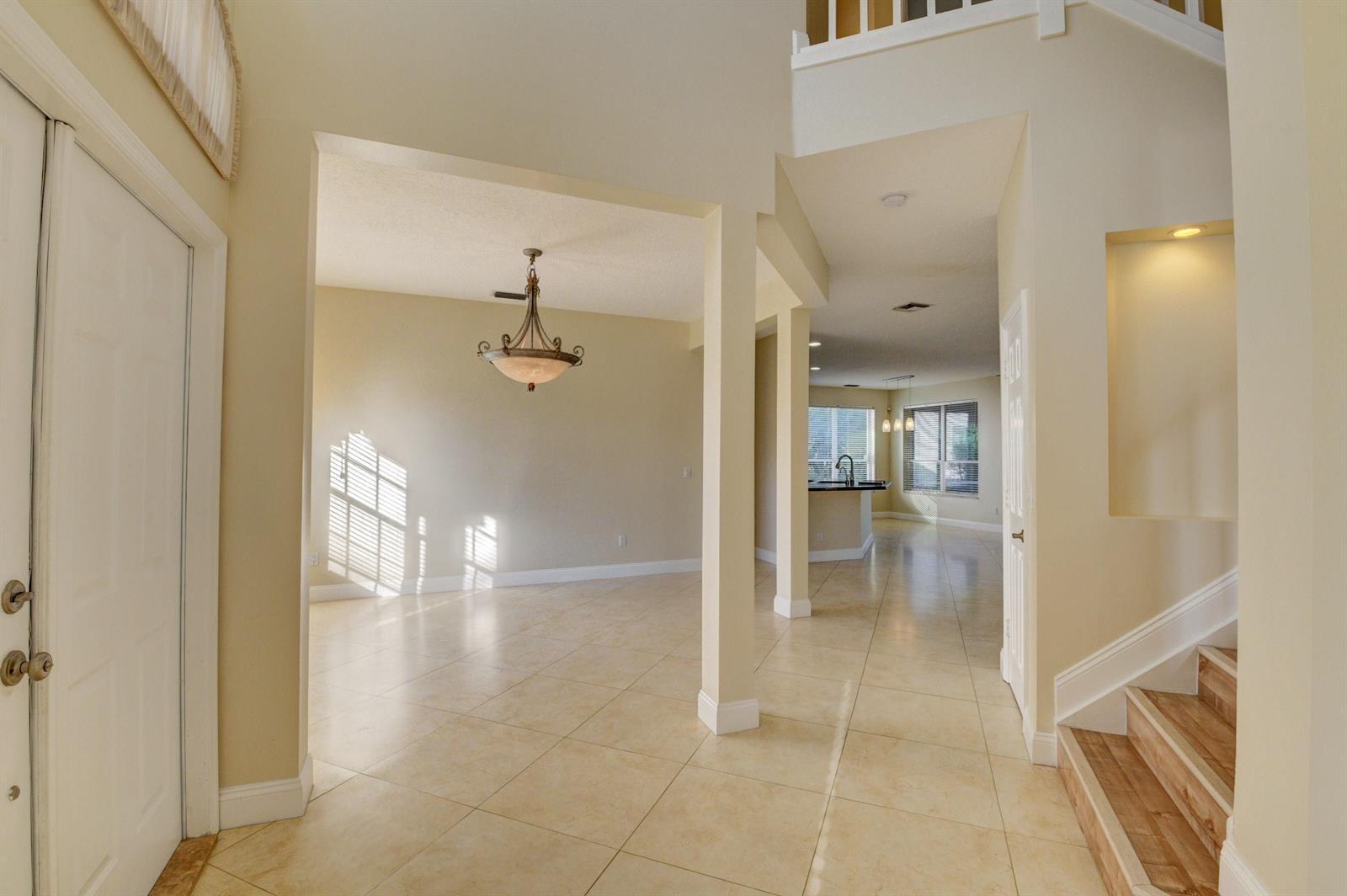 12920 Hyland Circle Boca Raton, FL 33428 - Photo 4 of 31 a view of a hallway with wooden floor and a bathroom