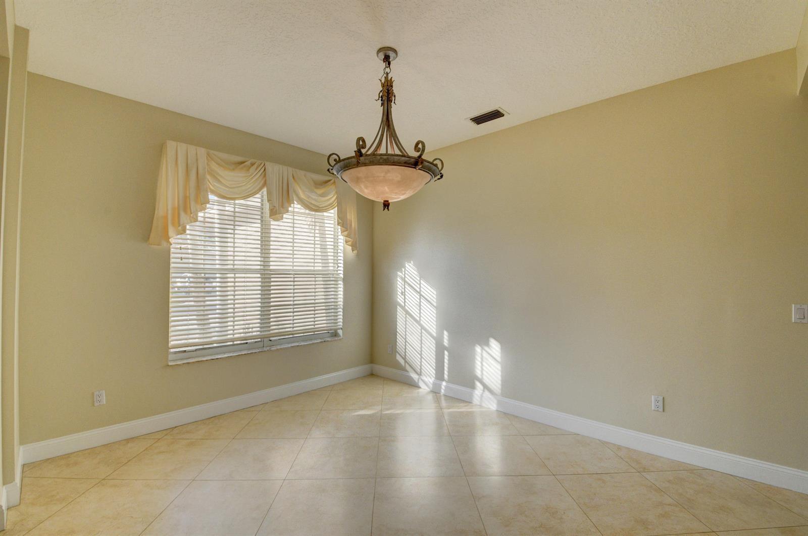 12920 Hyland Circle Boca Raton, FL 33428 - Photo 5 of 31 a view of an empty room with a window