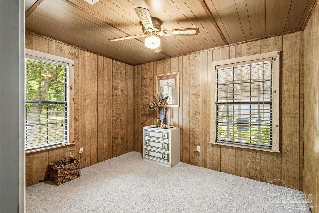 8938 Pioneer Road Holt, FL 32564 - Photo 23 of 44 a bedroom with furniture and a window