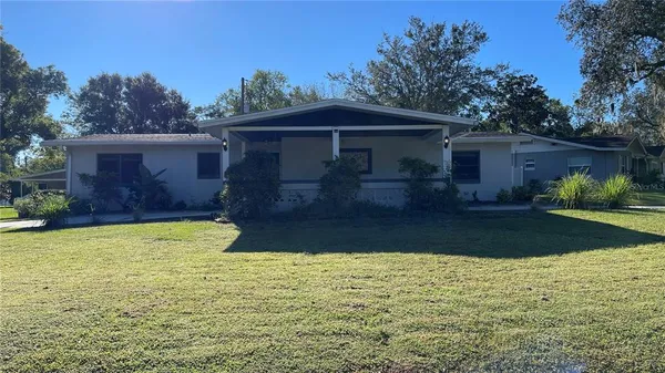 a front view of house with yard and trees