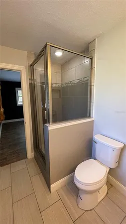 a bathroom with a toilet and a shower