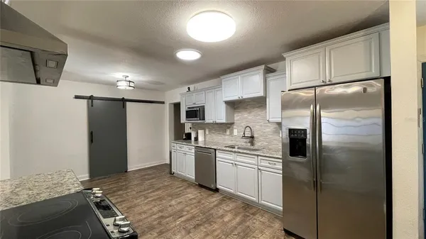 a kitchen with a sink stainless steel appliances and cabinets