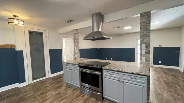 a kitchen with a sink and a refrigerator