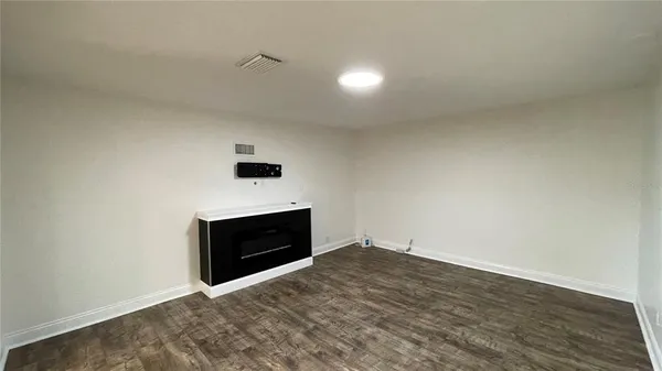 a view of an empty room and fire place