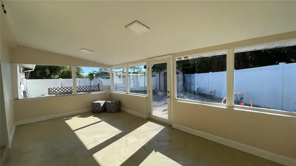 a living room with a couch and a floor to ceiling window