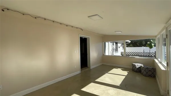 a view of a bedroom with furniture and window
