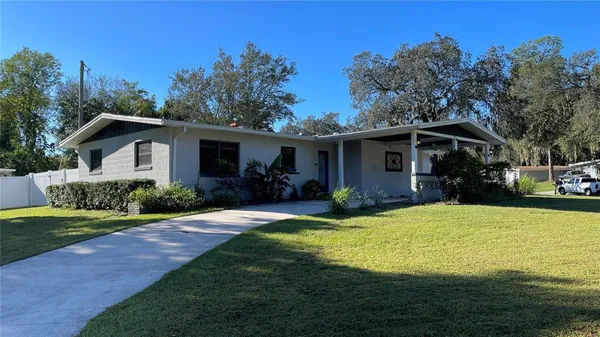 a front view of a house with yard porch and green space