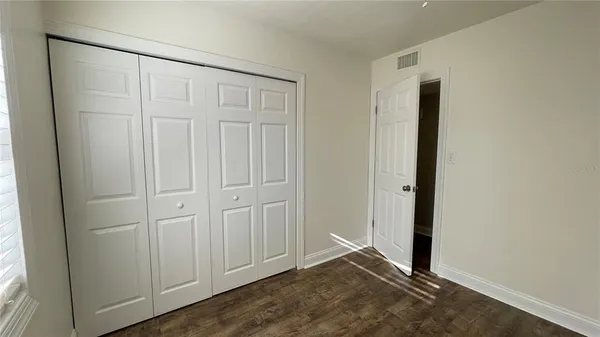 an empty room with wooden floor