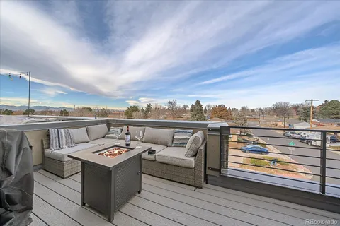 a view of a terrace with couches and sky view