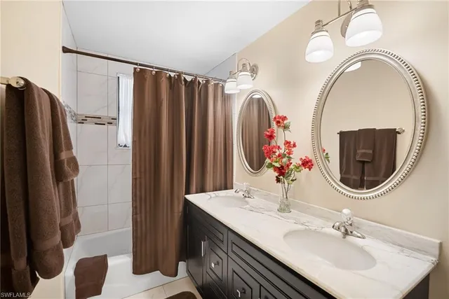 a bathroom with a sink a mirror a toilet and a shower