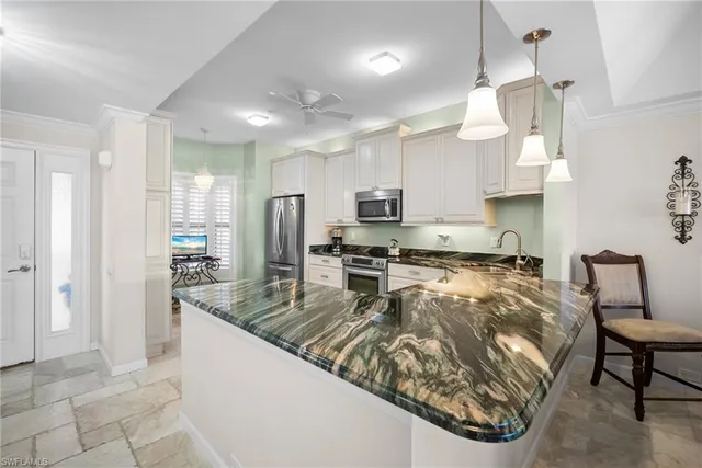 a large white kitchen with cabinets