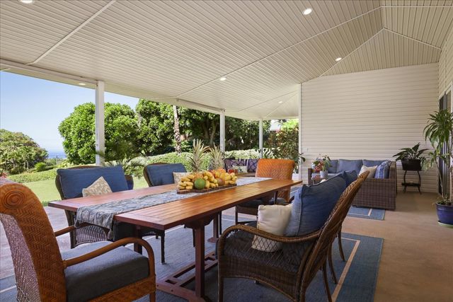 a outdoor dining space with furniture and garden view