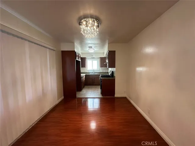 a view of a kitchen with a sink a kitchen counter space and stainless steel appliances