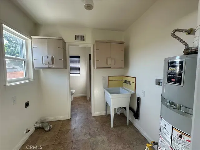 a view of a hallway with workspace and a window