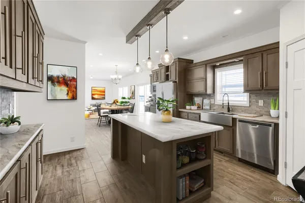 a kitchen with stainless steel appliances granite countertop a sink stove and wooden floor