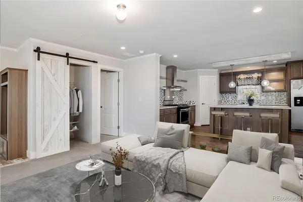 a living room with furniture and a chandelier