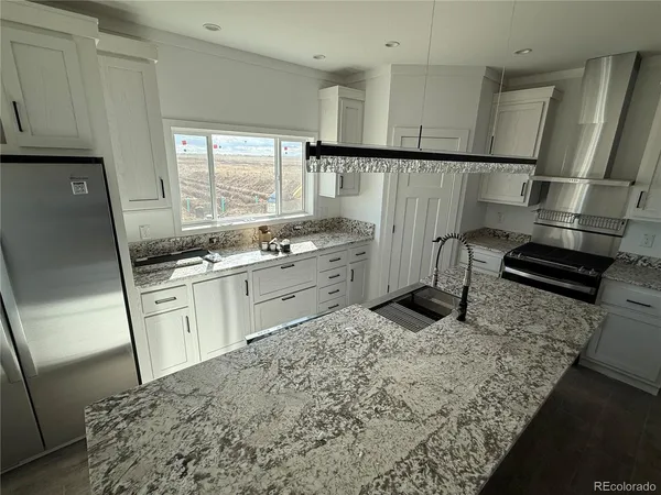 a kitchen with a sink stove and refrigerator