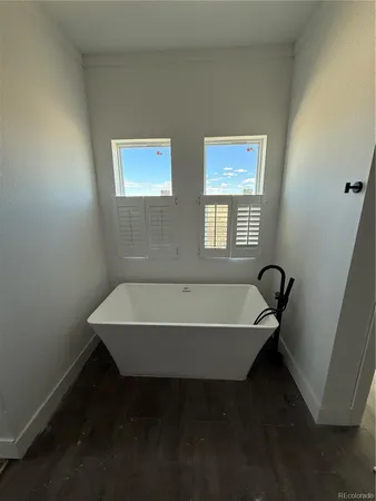 a bath tub sitting in a bathroom next to a window