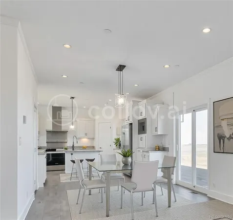 a view of a dining room kitchen with furniture and a chandelier