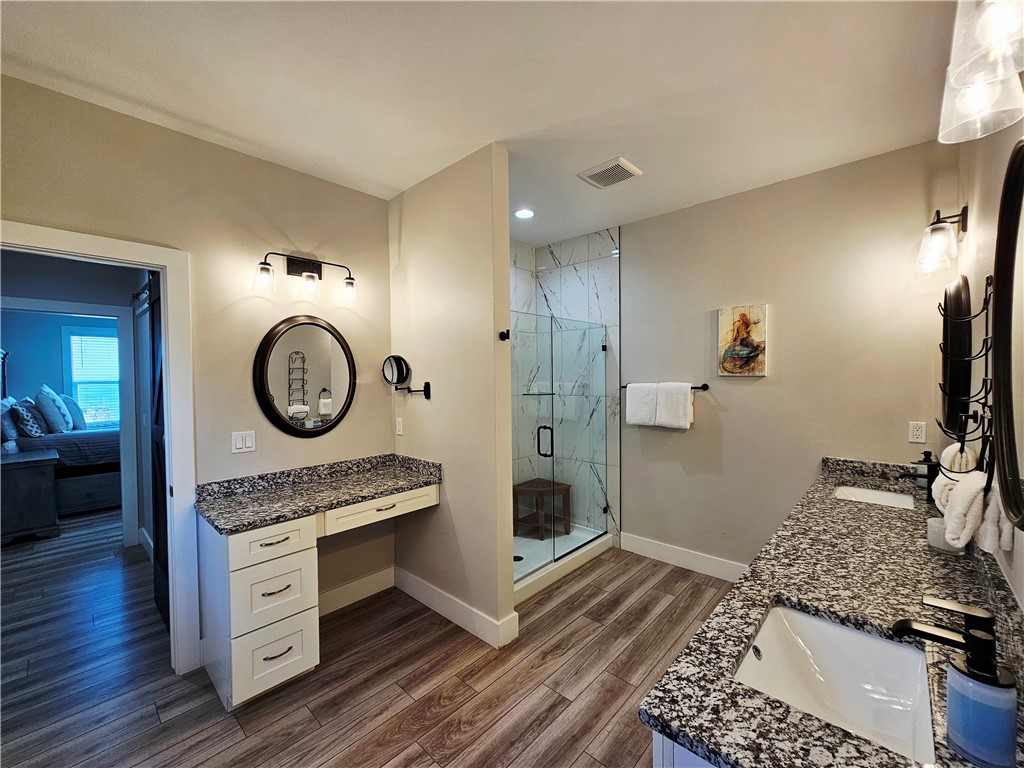 122 Ridge Harbor Drive Rockport, TX 78382 - Photo 28 of 34 a spacious bathroom with a granite countertop sink a mirror and shower