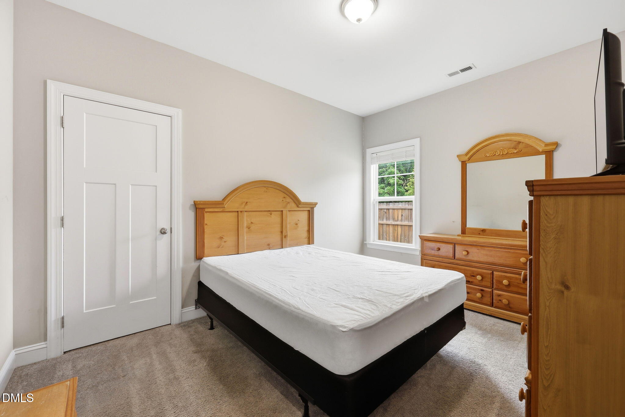 709 South Pollock Street Selma, NC 27576 - Photo 18 of 30 a bedroom with a bed and a dresser