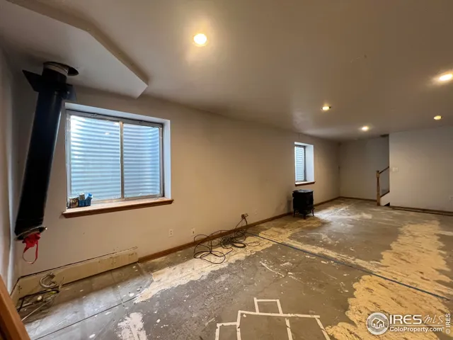 a view of an empty room and a window