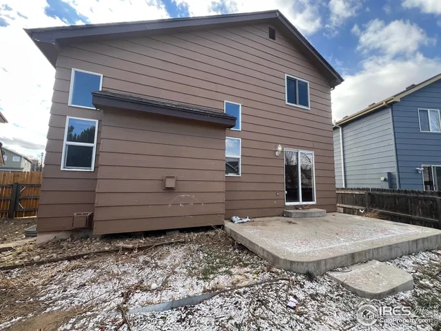 a backyard of a house with shaded area
