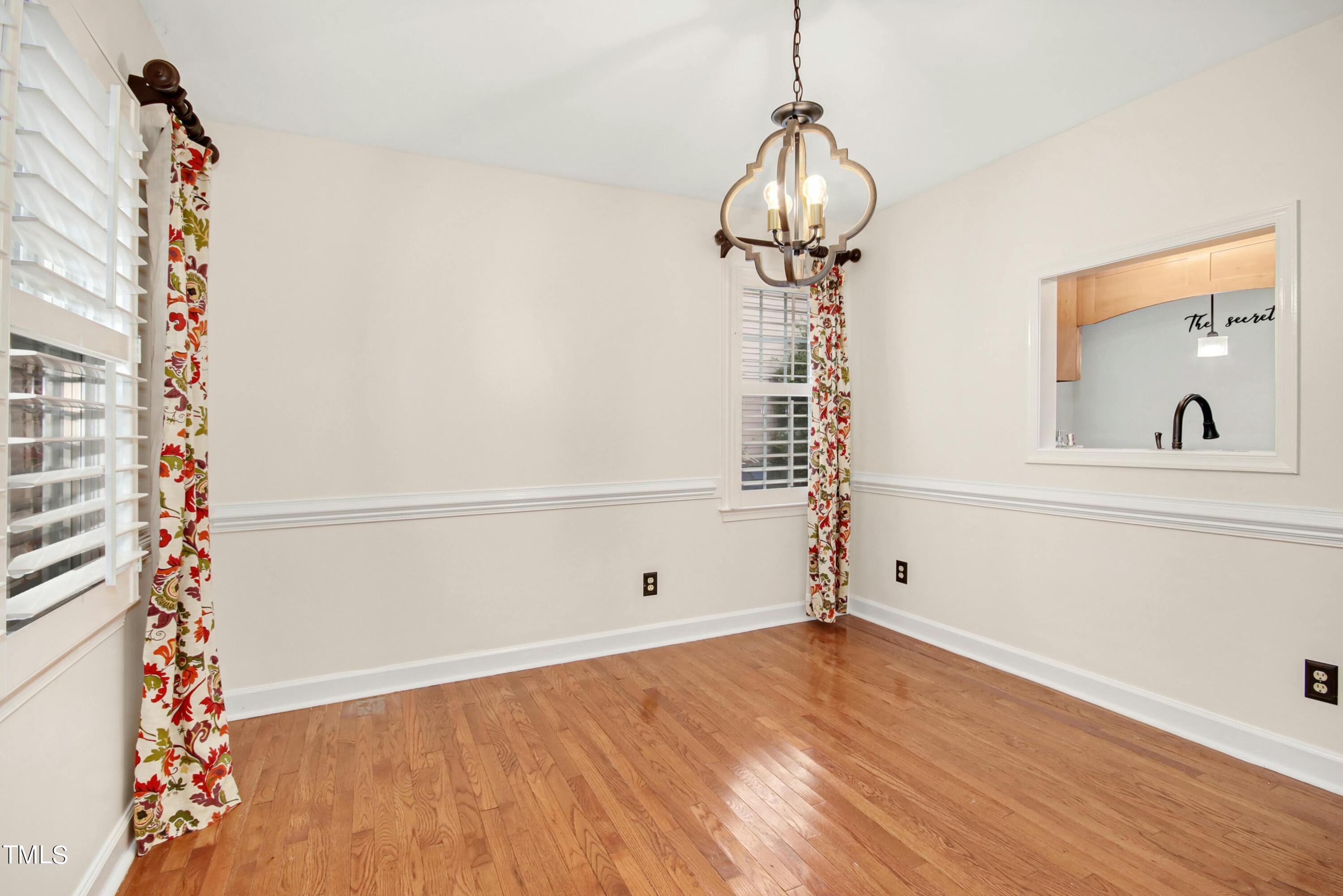 8605 Yucca Trail Raleigh, NC 27615 - Photo 13 of 42 a view of empty room with wooden floor and fan