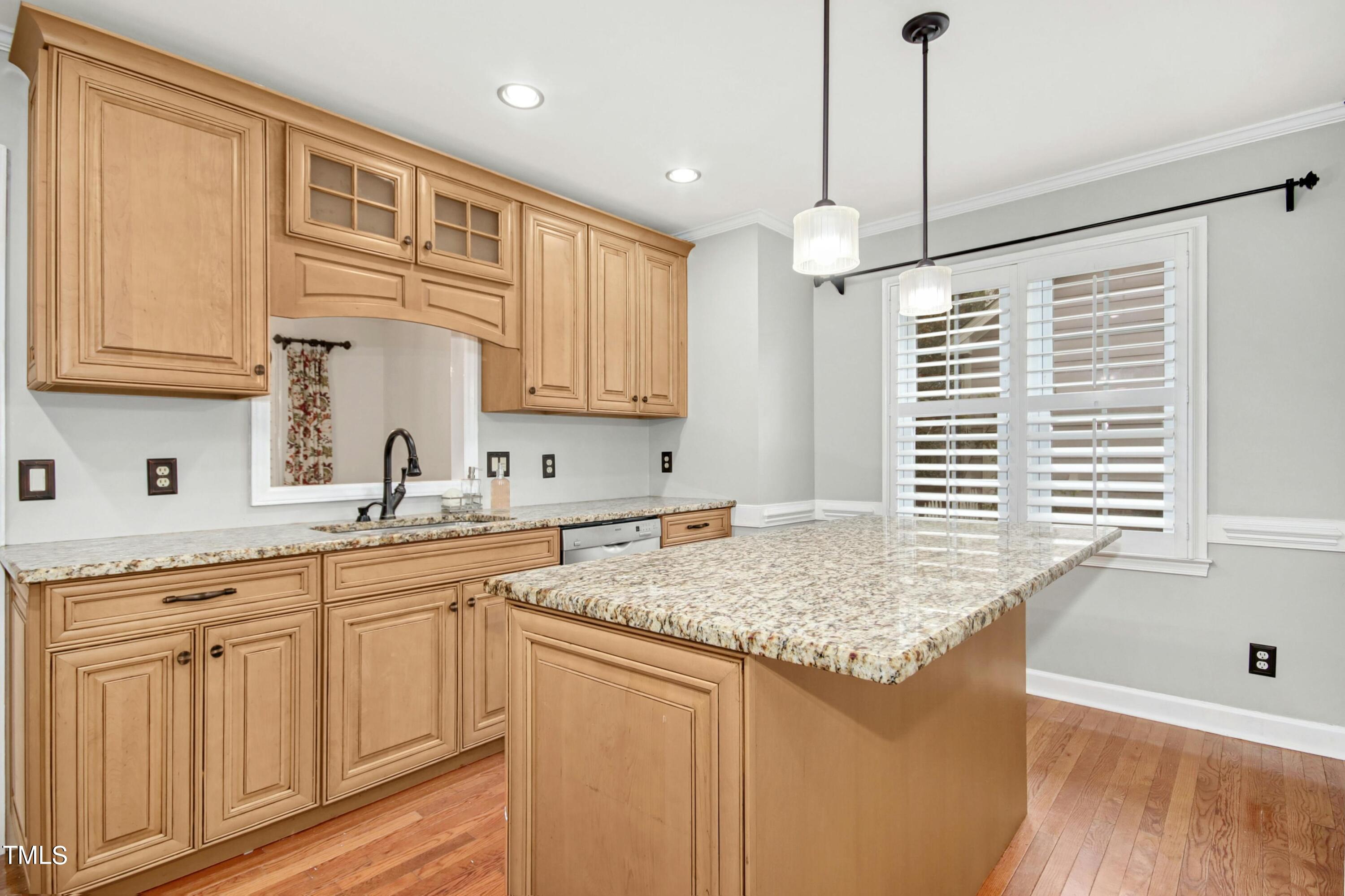 8605 Yucca Trail Raleigh, NC 27615 - Photo 15 of 42 a kitchen with stainless steel appliances granite countertop a sink a window and white cabinets