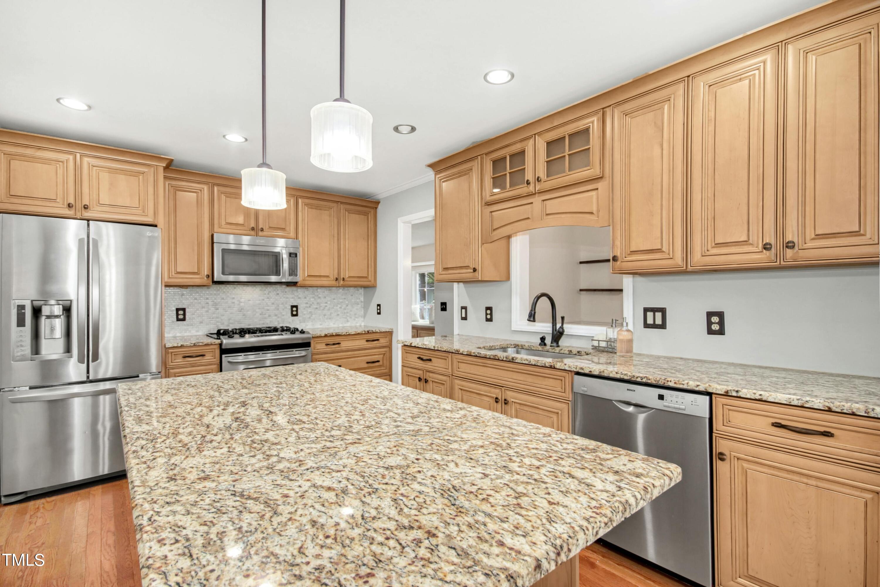 8605 Yucca Trail Raleigh, NC 27615 - Photo 16 of 42 a kitchen with stainless steel appliances granite countertop a refrigerator sink and cabinets