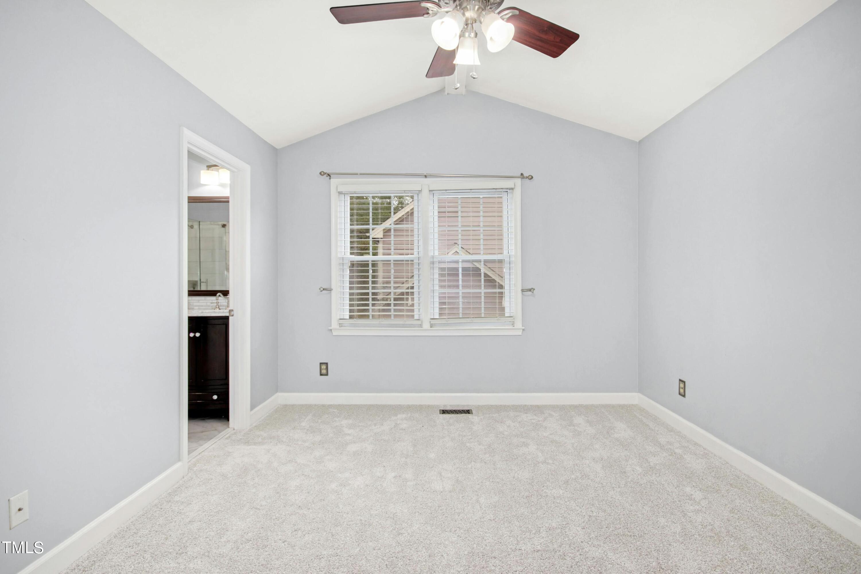 8605 Yucca Trail Raleigh, NC 27615 - Photo 18 of 42 an empty room with windows and chandelier fan