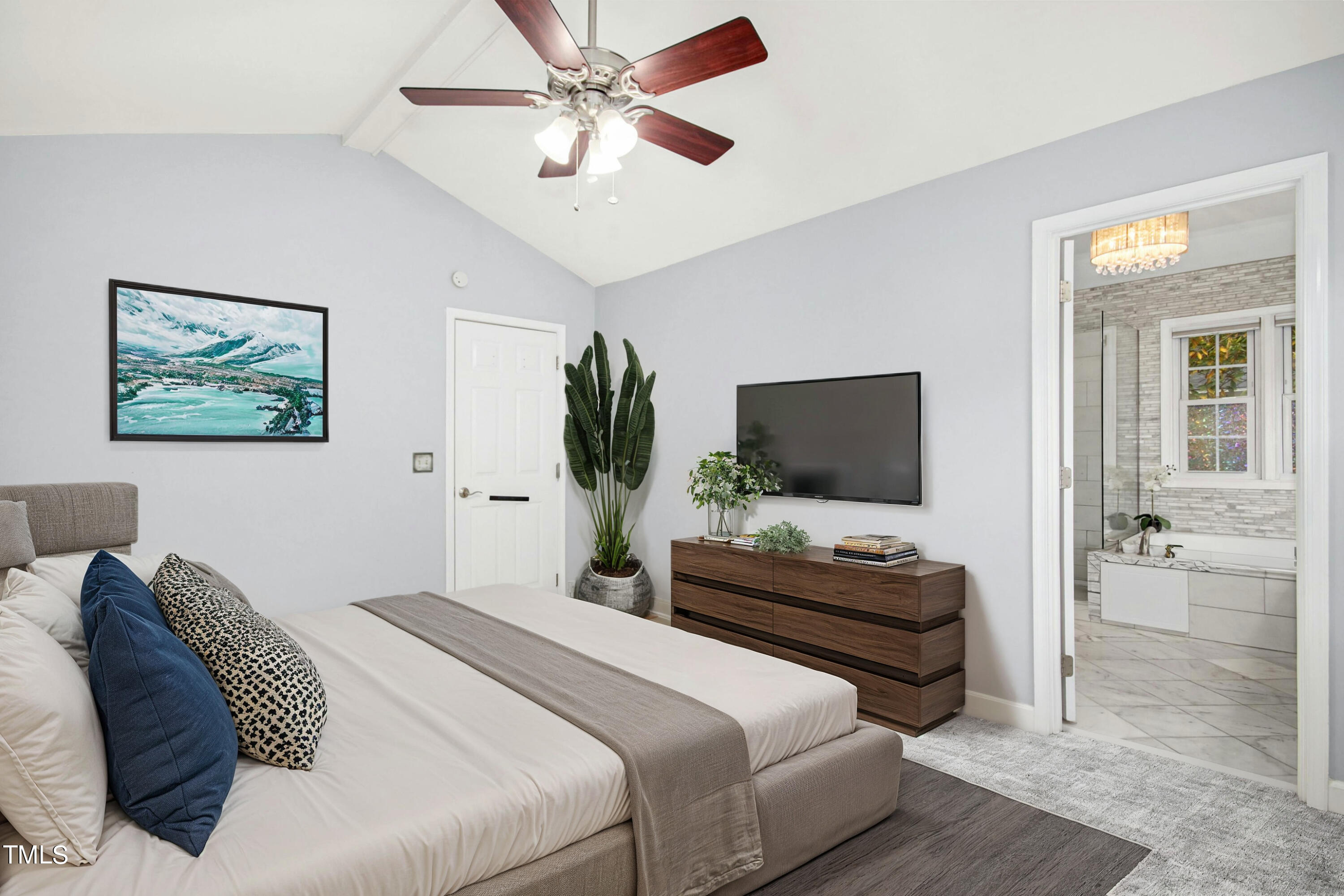 8605 Yucca Trail Raleigh, NC 27615 - Photo 19 of 42 a bedroom with a bed a couch and a flat screen tv