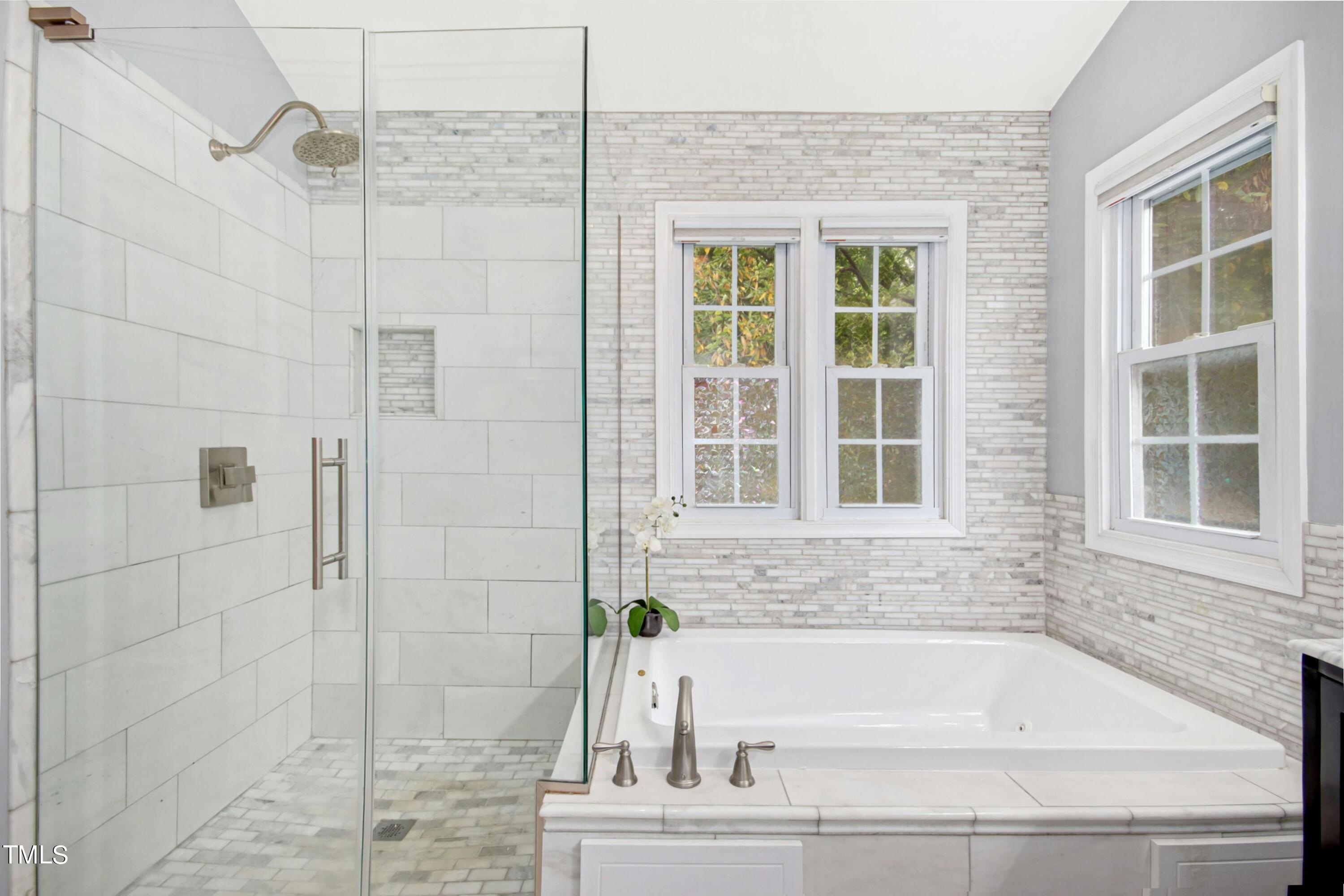 8605 Yucca Trail Raleigh, NC 27615 - Photo 23 of 42 a bathroom with a bathtub and shower