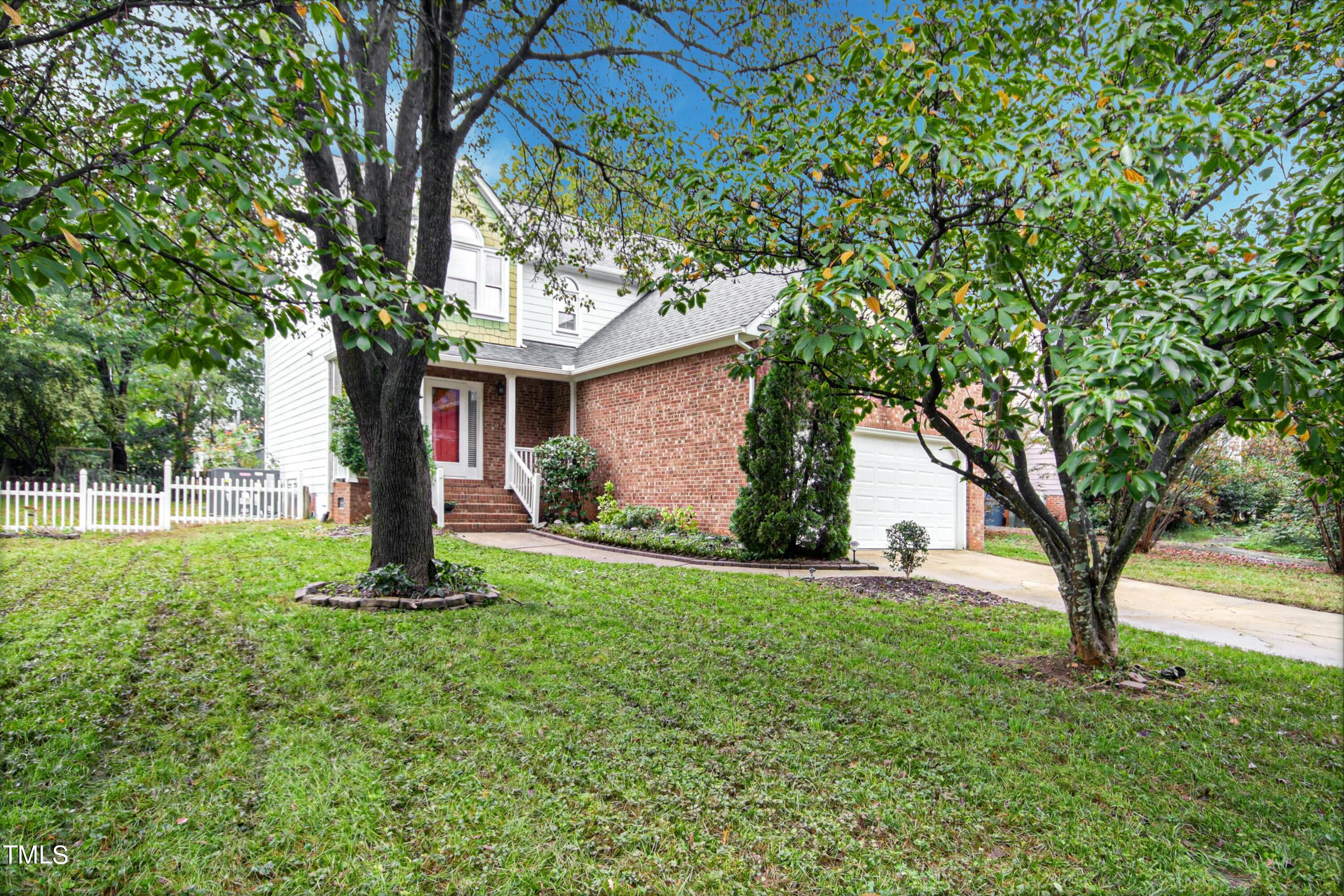 8605 Yucca Trail Raleigh, NC 27615 - Photo 41 of 42 a front view of house with yard and tree