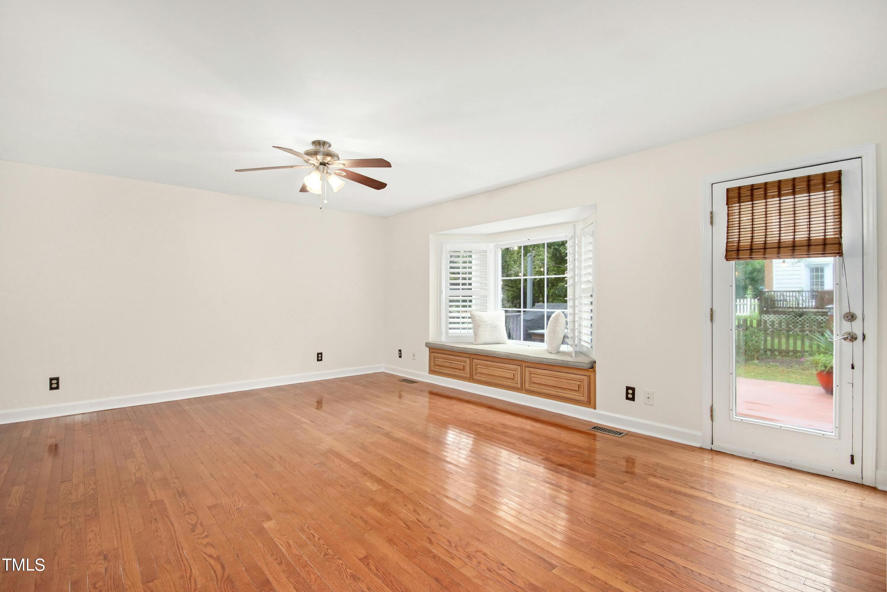 8605 Yucca Trail Raleigh, NC 27615 - Photo 8 of 42 an empty room with wooden floor and windows