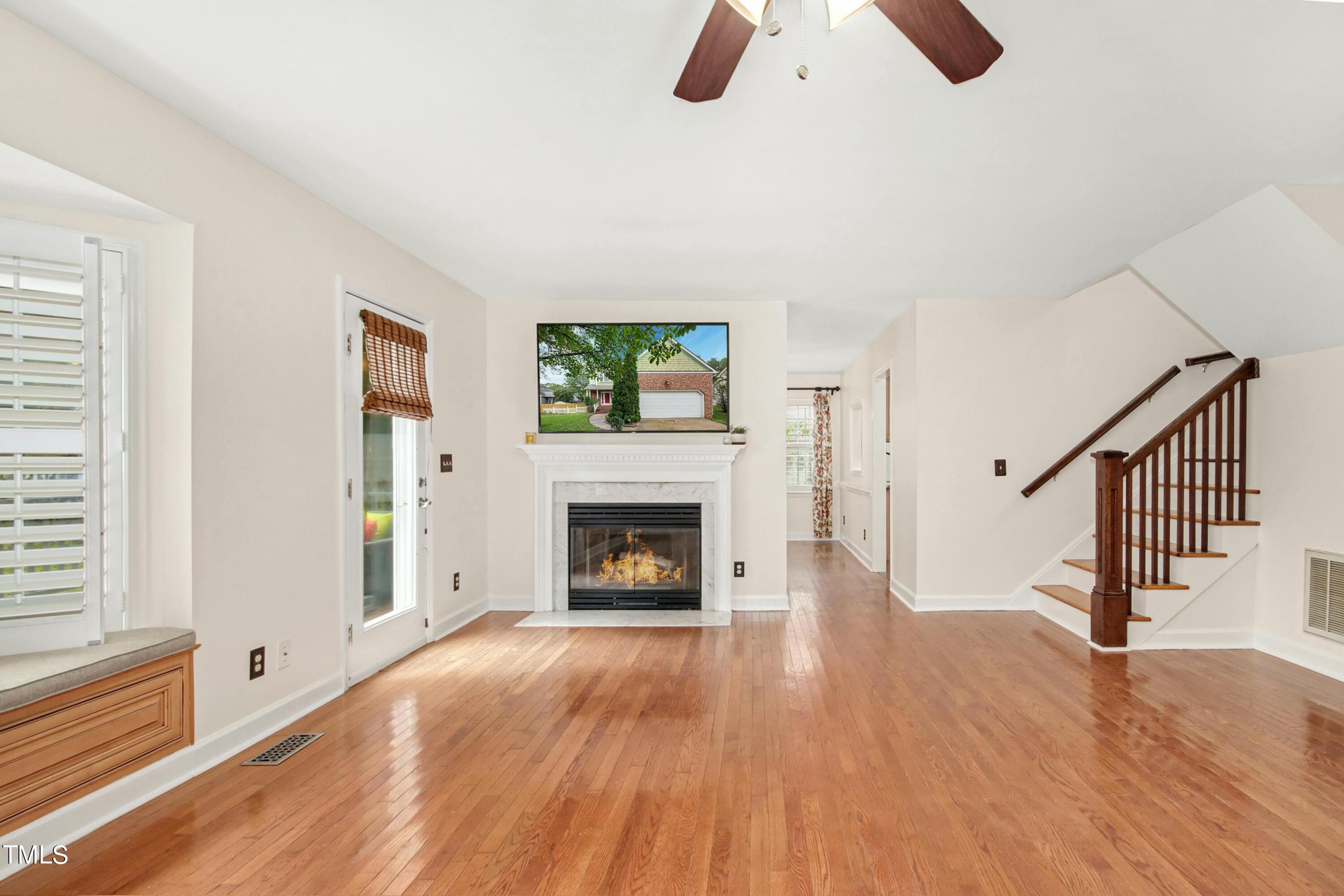 8605 Yucca Trail Raleigh, NC 27615 - Photo 9 of 42 a view of an empty room with wooden floor fireplace and a window